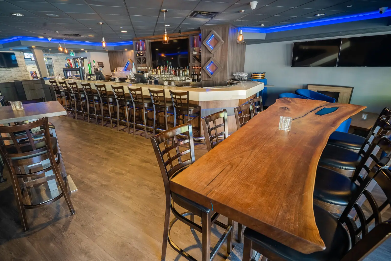 Sophisticated upper lounge with stylish bar at The Port House, Burlington - a chic space for guests to unwind and enjoy premium drinks.