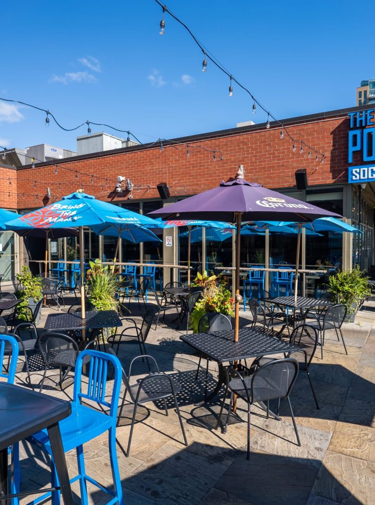 Charming patio area at The Port House, Burlington, featuring the venue's signature sign, perfect for al fresco dining and events.